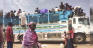 People board a truck as they leave Khartoum, Sudan, on June 19, 2023. Sudan has been torn by war for a year now, torn by fighting between the military and the notorious paramilitary Rapid Support Forces. © AP