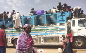 People board a truck as they leave Khartoum, Sudan, on June 19, 2023. Sudan has been torn by war for a year now, torn by fighting between the military and the notorious paramilitary Rapid Support Forces. © AP