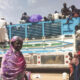 People board a truck as they leave Khartoum, Sudan, on June 19, 2023. Sudan has been torn by war for a year now, torn by fighting between the military and the notorious paramilitary Rapid Support Forces. © AP