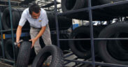 An employee scans tires at a tire factory.