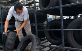 An employee scans tires at a tire factory.