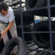 An employee scans tires at a tire factory.