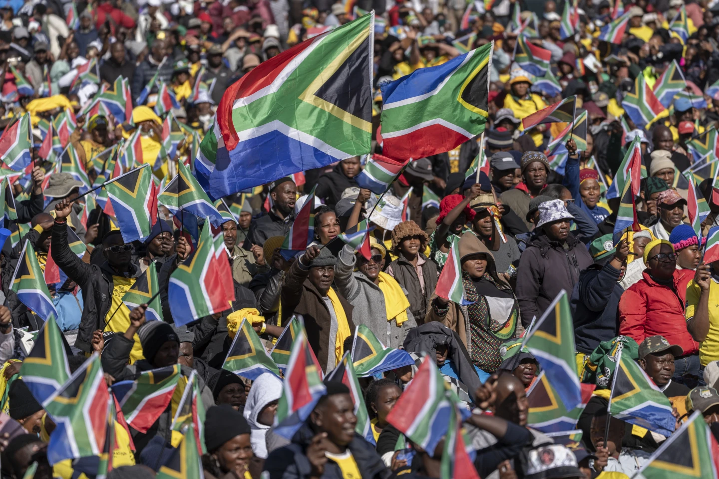 South Africans cheer ahead of the inauguration of South Africa’s Cyril Ramaphosa as President at the Union Buildings South Lawns in Tshwane, South Africa, Wednesday, June 19, 2024. (AP Photo/Jerome Delay)