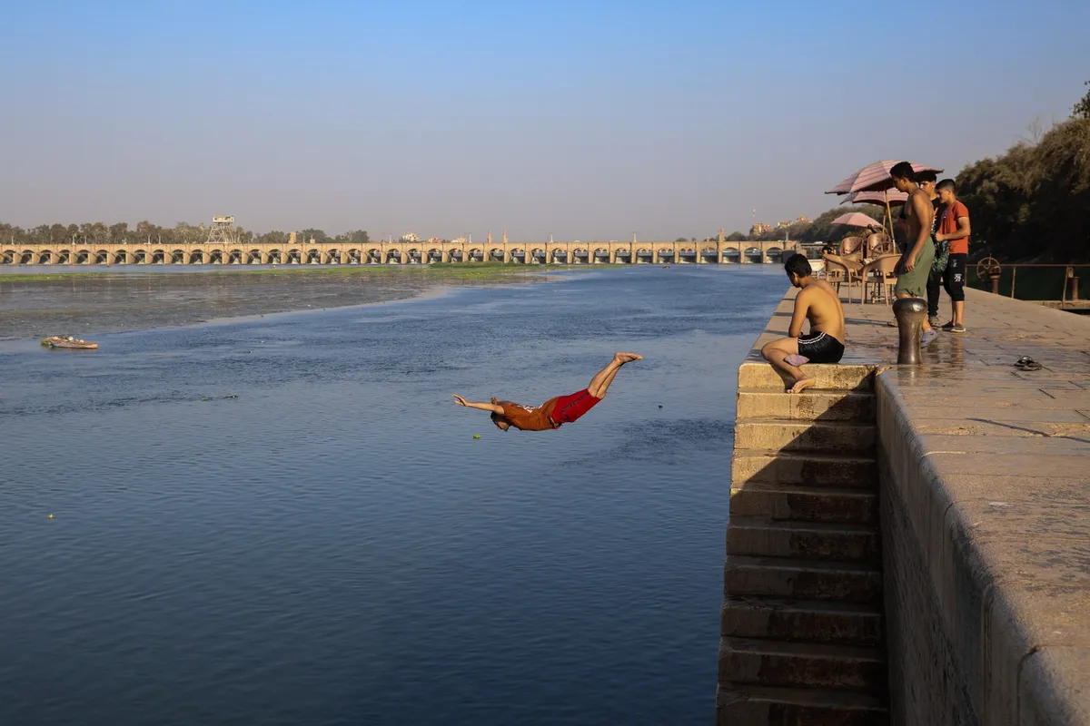 Youths cool off in the River Nile.Photographer: Islam Safwat/Bloomberg