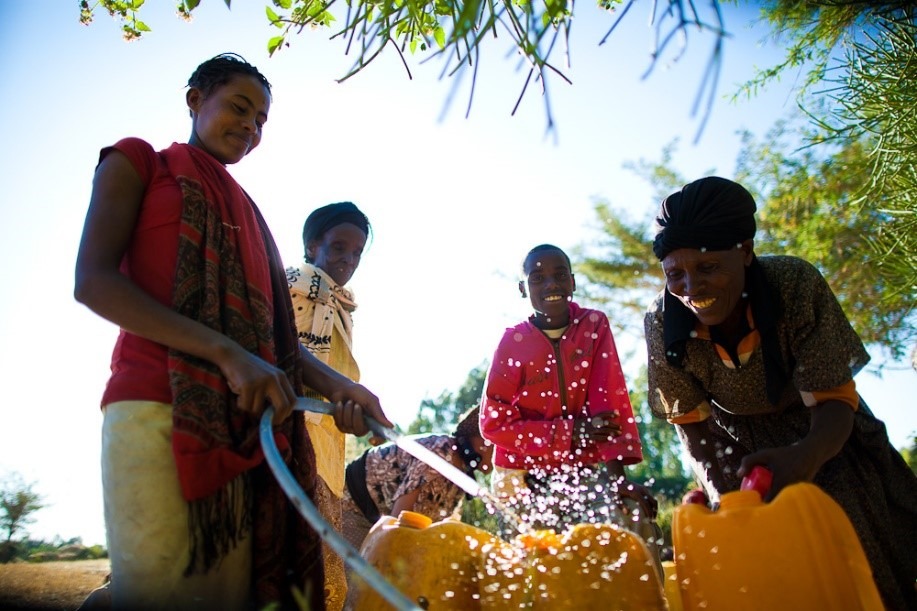 Women in Ethiopia collecting clean drinking water. [Photo Credit: USAID Flickr]