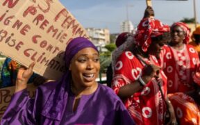 Climate activist Khady Camara leads a women's march in Dakar, Senegal, on Saturday ahead of the COP29 summit in Azerbaijan. One of their banners reads: "Soum district has had no clean drinking water since 2015."