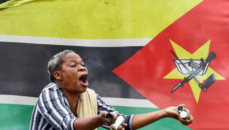 On Thursday, this woman voices her outrage and holds up tear-gas canisters fired by security forces at protesters in Mozambique. Election observers say they found evidence of vote-tampering during October's general election, and opposition demonstrations continue.